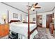 Bedroom featuring a four-poster bed, ceiling fan, wooden furniture, and a decorative rug at 1531 Wheaton Nw Way, Concord, NC 28027