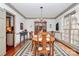 Charming dining room with hardwood floors, chandelier, and view of the backyard at 1531 Wheaton Nw Way, Concord, NC 28027