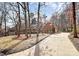 Inviting brick home with a long driveway, attached garage, and manicured lawn, surrounded by mature trees at 1531 Wheaton Nw Way, Concord, NC 28027