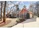 Traditional brick home with dormer windows, a covered porch, and lush landscaping creating a serene curb appeal at 1531 Wheaton Nw Way, Concord, NC 28027