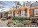 Charming brick home featuring a welcoming front porch, dormer windows, and beautifully landscaped front yard at 1531 Wheaton Nw Way, Concord, NC 28027