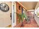 Charming front porch with brick flooring, a welcoming wreath, and comfortable seating, creating an inviting outdoor space at 1531 Wheaton Nw Way, Concord, NC 28027