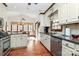 Bright kitchen features a stainless steel dishwasher, granite countertops, and hardwood floors at 1531 Wheaton Nw Way, Concord, NC 28027