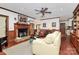 Spacious living room features a fireplace, hardwood floors, and a ceiling fan at 1531 Wheaton Nw Way, Concord, NC 28027