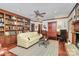 Cozy living room featuring built-in bookshelves, hardwood floors, and a ceiling fan at 1531 Wheaton Nw Way, Concord, NC 28027