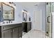 Modern bathroom with double vanities, stylish mirrors, and elegant lighting fixtures at 17847 Caldwell Track Dr, Cornelius, NC 28031