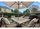 Outdoor patio featuring a dining table, seating and an umbrella, perfect for entertaining at 18334 Dembridge Dr, Davidson, NC 28036