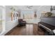 Cozy living room with hardwood floors, natural light, piano, and decorative guitars at 18334 Dembridge Dr, Davidson, NC 28036