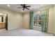 Neutral bedroom featuring a ceiling fan and large window with decorative curtains at 1838 Landry Ln, Rock Hill, SC 29732