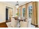 Bright dining area featuring a wood table, comfortable chairs, large windows, and stylish decor at 1838 Landry Ln, Rock Hill, SC 29732