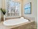 Bright bathroom with soaking tub, natural light from large window and tile floor at 1838 Landry Ln, Rock Hill, SC 29732