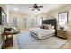 Spacious main bedroom with large windows, sitting area, ceiling fan and a tufted headboard at 1838 Landry Ln, Rock Hill, SC 29732