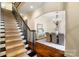 Elegant staircase leading to a formal dining room with chandelier and hardwood floors at 1838 Landry Ln, Rock Hill, SC 29732