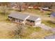 Aerial view of a home featuring brick exterior, attached garage, and a well-maintained lawn and landscape at 19 Harolds Ct, Taylorsville, NC 28681