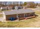 Aerial view of a brick house featuring a backyard wooden deck and attached garage at 19 Harolds Ct, Taylorsville, NC 28681