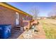 View of the backyard featuring a brick home with a wooden deck and an expansive green lawn at 19 Harolds Ct, Taylorsville, NC 28681