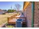 View of the wooden deck in the backyard of a brick home, with an AC unit at 19 Harolds Ct, Taylorsville, NC 28681