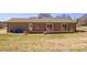 View of a brick home featuring a wooden deck, a door and sliding glass doors, and an expansive backyard at 19 Harolds Ct, Taylorsville, NC 28681