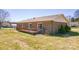 Side view of a brick home showing the deck, sliding glass doors, air conditioner, and expansive backyard at 19 Harolds Ct, Taylorsville, NC 28681