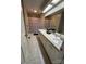 Well-lit bathroom with double sinks, a vanity with plenty of storage, and a skylight at 19 Harolds Ct, Taylorsville, NC 28681