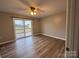 Bright bedroom boasts wood-look flooring, a ceiling fan, and sliding glass doors to the outdoor deck at 19 Harolds Ct, Taylorsville, NC 28681