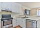 Kitchen with stainless steel appliances, white cabinets, and ample counter space at 19 Harolds Ct, Taylorsville, NC 28681