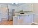 Kitchen featuring white cabinets, breakfast bar, and stainless steel refrigerator at 19 Harolds Ct, Taylorsville, NC 28681