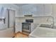 Traditional kitchen features a stainless-steel fridge, electric stove, and double basin sink at 19 Harolds Ct, Taylorsville, NC 28681