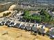 Aerial view of a residential area, showcasing home rooftops, a pond, and golf course at 2018 Links View Dr, Fort Mill, SC 29707