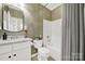 Well-maintained bathroom featuring a vanity with granite countertop, decorative mirror, and a shower-tub combination at 2018 Links View Dr, Fort Mill, SC 29707