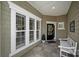 Cozy front porch features a bench and windows with white trim and a storm door at 2018 Links View Dr, Fort Mill, SC 29707