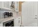 Stylish laundry area featuring a wine fridge, granite counters, and white cabinetry at 2018 Links View Dr, Fort Mill, SC 29707