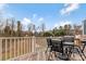 Back deck with a table, chairs and gas grill, overlooking a wooded area at 2175 Autumn Cyprus Ave, Gastonia, NC 28054