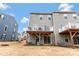 View of the home's exterior and the backyard featuring a small deck with furniture at 2175 Autumn Cyprus Ave, Gastonia, NC 28054