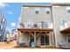 Back of the house with a deck and outdoor furniture, and stairs leading down to the yard at 2175 Autumn Cyprus Ave, Gastonia, NC 28054