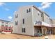 Rear view of home showcasing the backyard, deck, and multi-story layout at 2175 Autumn Cyprus Ave, Gastonia, NC 28054