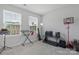 Bright bedroom featuring two windows, an electronic drum set, keyboard, and a basketball hoop at 2175 Autumn Cyprus Ave, Gastonia, NC 28054