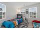 Bright bedroom featuring colorful decor, playful accessories, and two large windows at 2175 Autumn Cyprus Ave, Gastonia, NC 28054