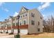 Exterior view of townhome with brick and neutral siding, showcasing a two-car garage at 2175 Autumn Cyprus Ave, Gastonia, NC 28054