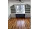 Cozy bedroom features hardwood floors, natural light, and built-in shelving at 222 2Nd Ave, Albemarle, NC 28001