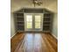 Cozy bedroom features hardwood floors, natural light, and built-in shelving at 222 2Nd Ave, Albemarle, NC 28001