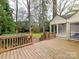 Spacious wooden back deck that overlooks the expansive, well-manicured lawn and a sunroom or enclosed porch at 2411 Calais Pl, Charlotte, NC 28211