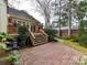 A brick patio and stairs lead to a charming backyard, perfect for outdoor entertaining and relaxation at 2411 Calais Pl, Charlotte, NC 28211