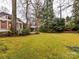 A spacious backyard with a lush lawn and mature trees, perfect for outdoor activities and relaxation at 2411 Calais Pl, Charlotte, NC 28211