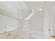 All-white bathroom with soaking tub, walk-in shower, and lots of mirrored surfaces at 2411 Calais Pl, Charlotte, NC 28211