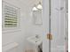 Bright half bathroom featuring a pedestal sink, open window with white blinds at 2411 Calais Pl, Charlotte, NC 28211