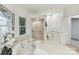 Bright bathroom featuring a luxurious soaking tub and separate glass shower enclosure at 2411 Calais Pl, Charlotte, NC 28211