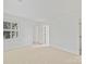 Bright bedroom with neutral walls, carpet, and open doorway with a view to another room at 2411 Calais Pl, Charlotte, NC 28211