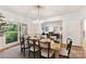 Dining room features stylish chairs and a modern chandelier, adjacent to the living room at 2411 Calais Pl, Charlotte, NC 28211