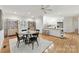 Open-concept dining room with hardwood floors, modern lighting, and access to the kitchen at 2411 Calais Pl, Charlotte, NC 28211